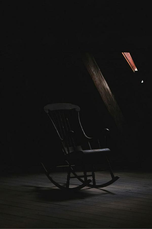 somber dark place with a rocking chair