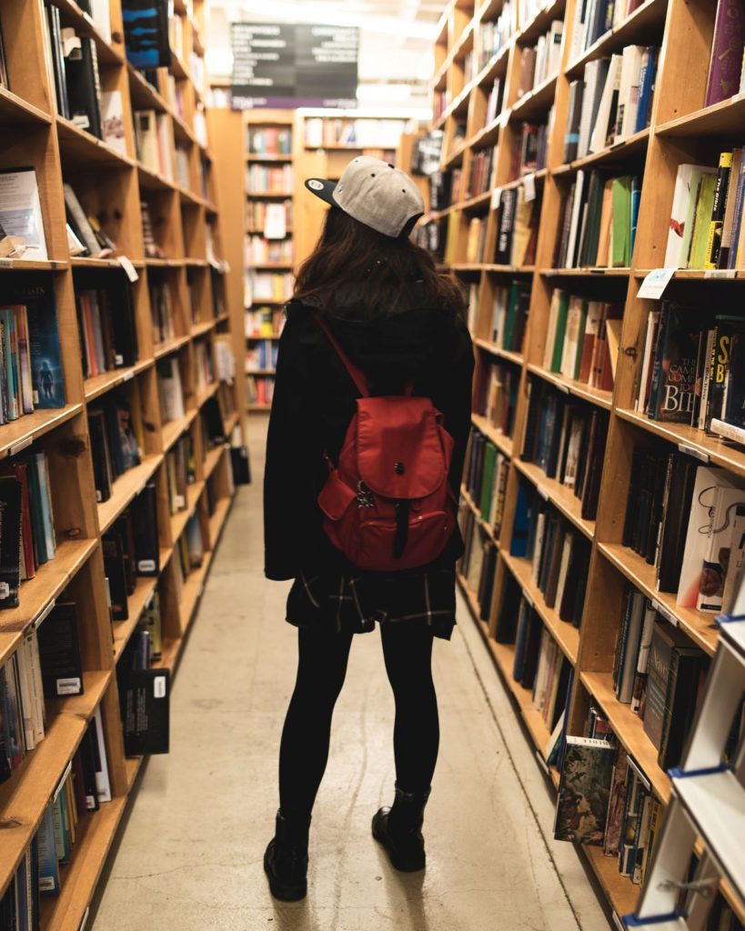 Woman in Bookstore Photo by Tyler Tang on Unsplash