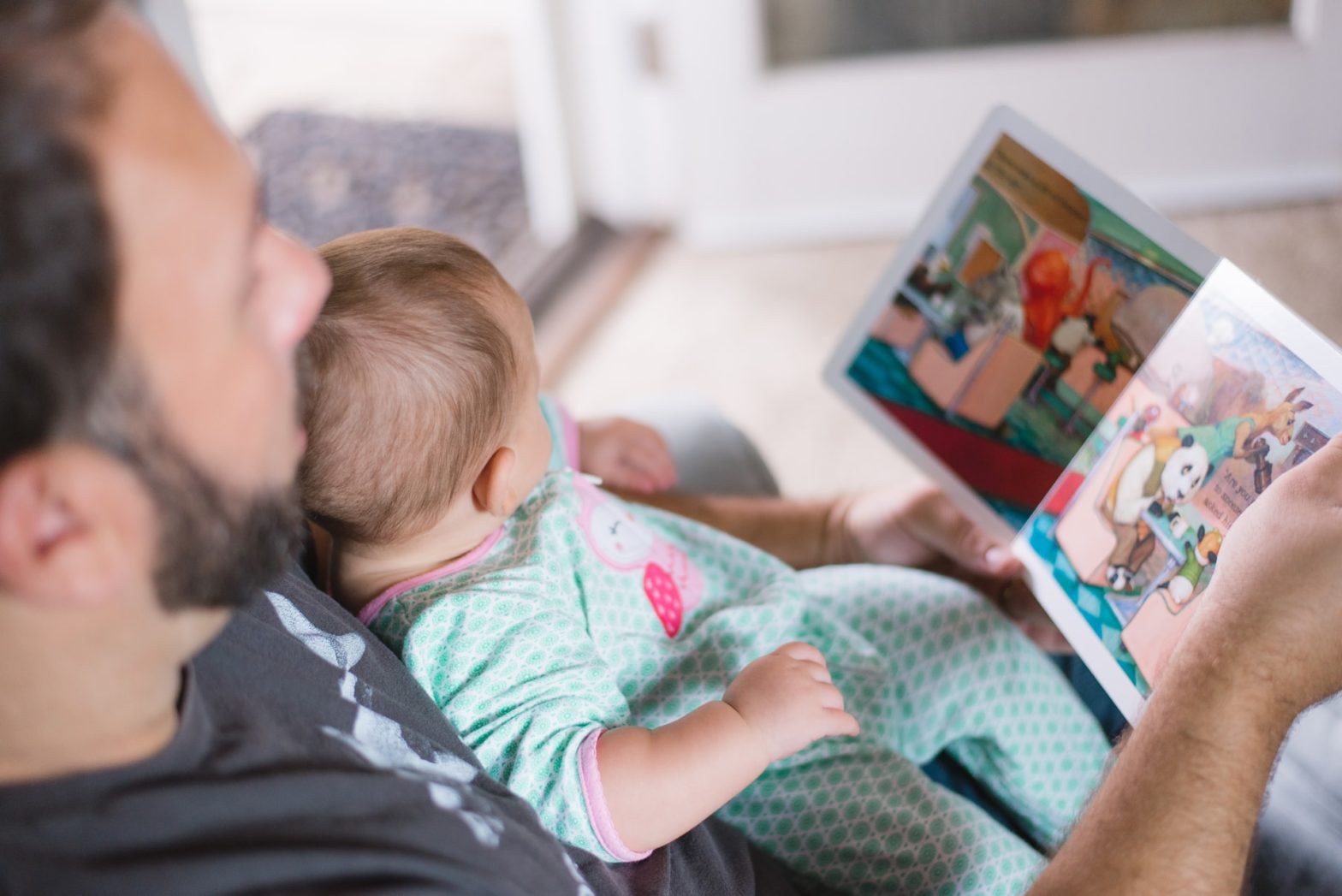 parent reading to pre-toddler